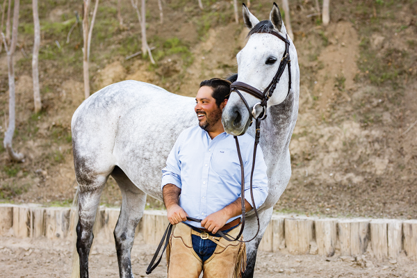 Trainer Chris Cervantes with a gray horse