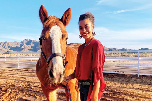 Nia Edwards, who created her beaded halter business while in high school, with her horse
