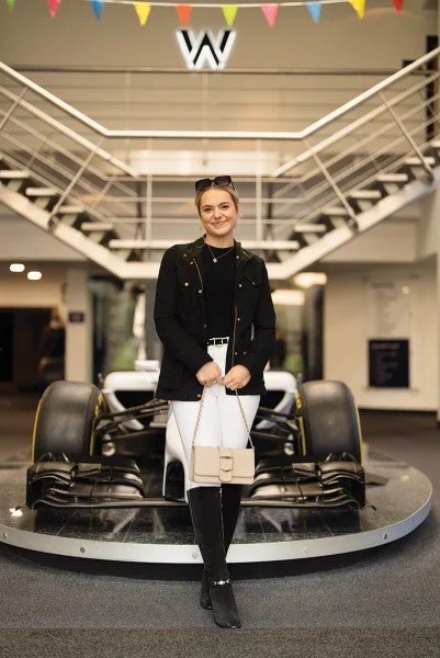 This Esme at an F1 event. Her family's interest in motosports is one of the fun facts about her.