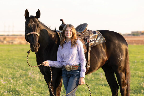 A young girl with her horse