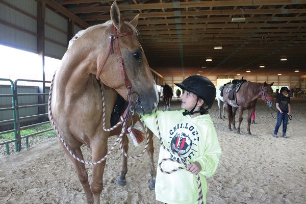 Lily and Pacman, her horse during her summer camp equestrian session at Camp Liberty.