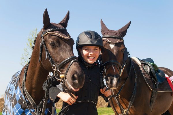Two girls displaying sportsmanship at a horse show, an important life lesson learned as an equestrian