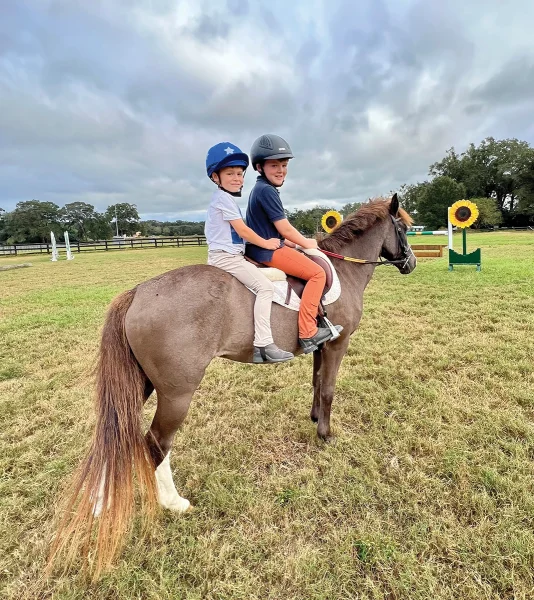 Siblings Saer and Flynn, who work together to train and market sales ponies, on Coco, their forever pony.