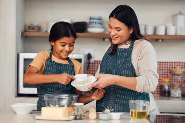 A mother and daughter baking together.