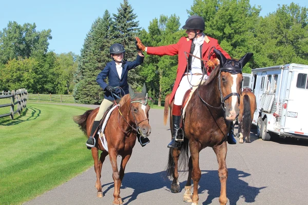 Ben high-fiving his dad while riding.