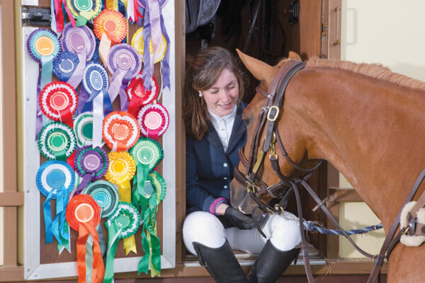 A rider calms her nerves with her pony at a horse show