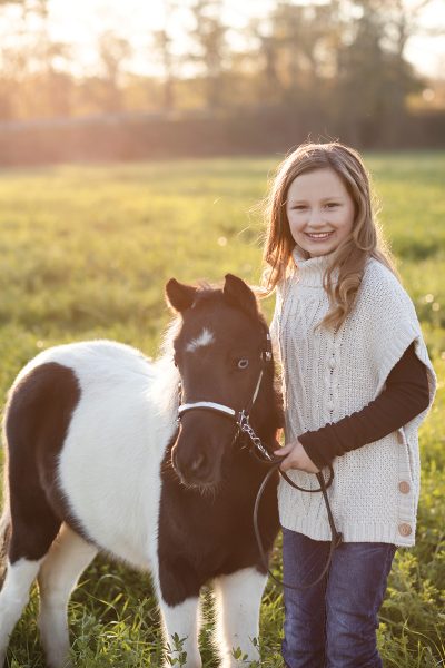 A young girl with a miniature horse