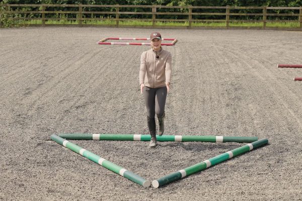 Esme demonstrating the setup of the poles.