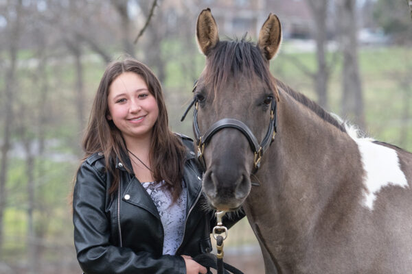 A young girl with her horse