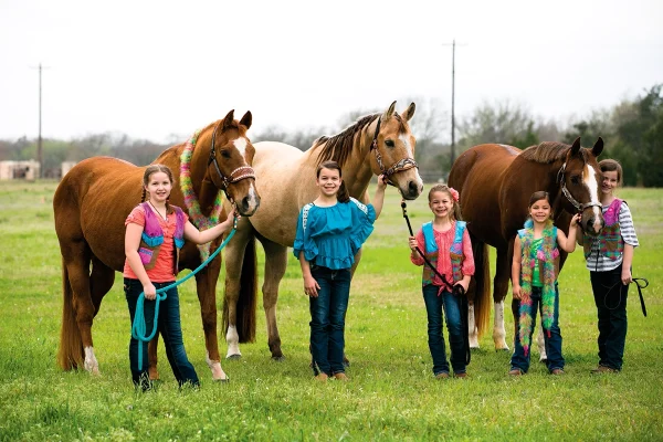 A group of young equestrians at summer horse camp.
