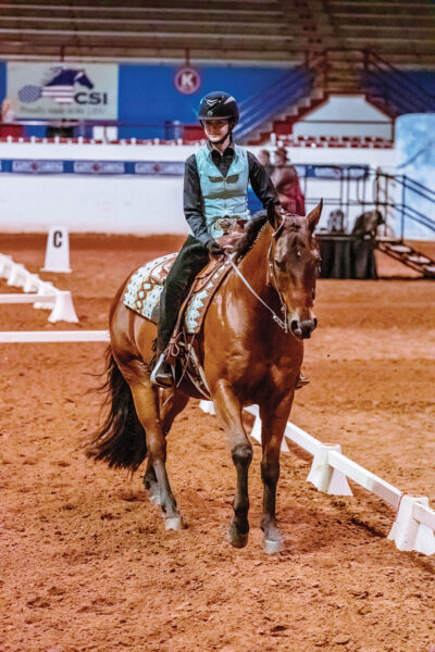 A young rider showing in western dressage