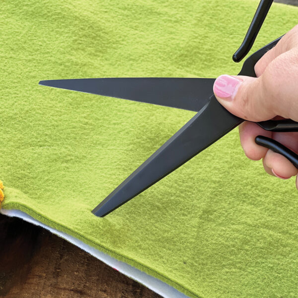 Using scissors to cut cloth