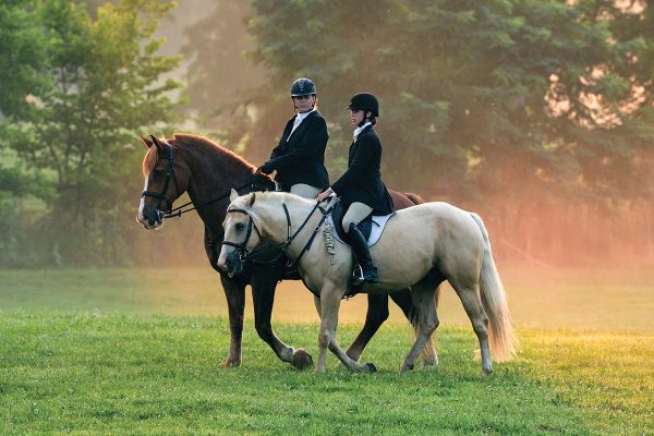 A mom and daughter riding together.