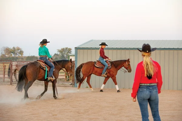Riders practicing proper arena etiquette and safety by riding deeper into the corners.