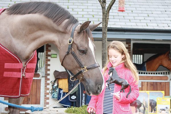 A young girl meeting Valegro.
