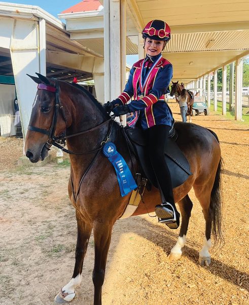 A youth on her pony at a show.