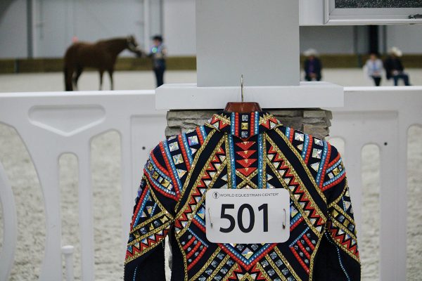 A showmanship jacket hanging in the warmup pen.