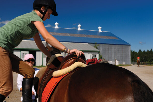 An equestrian getting on a horse