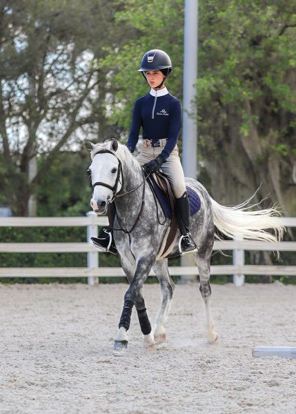 Katie trotting her pony, Bitcoin.