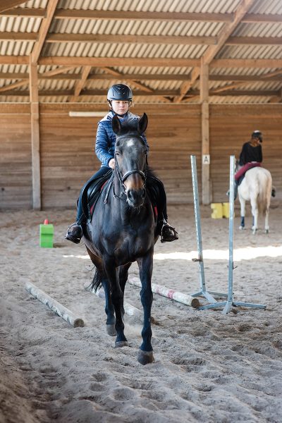 A young rider during a riding lesson.
