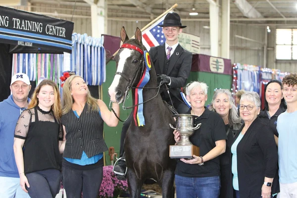Thirteen-year-old Justin, who is Deaf, credits the Morgan breed’s intuition and personality with his winning start in equestrian sport, as shown with his show ribbon.