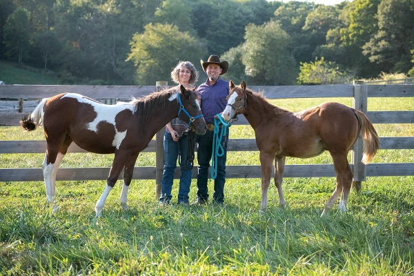 Stacy and Jesse Westfall with Stormy and Lefty, the foals that became best friends.