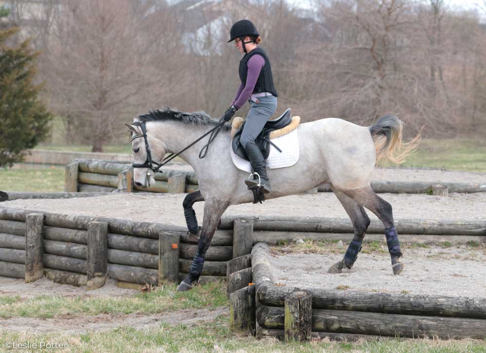 Jumping down a cross-country bank