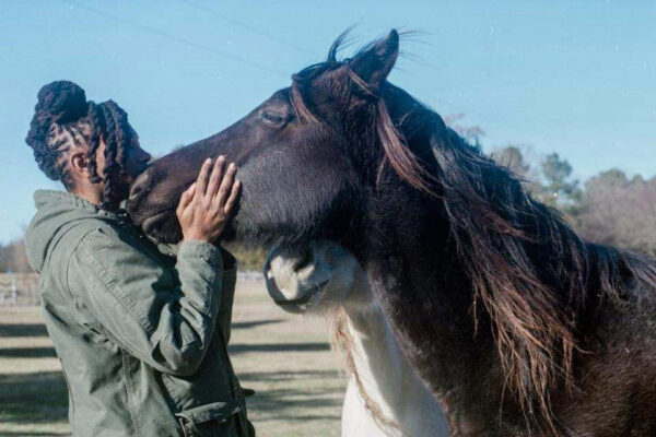 Caitlin Gooch, recipient of the ASPCA Equine Welfare Award, hugging a horse