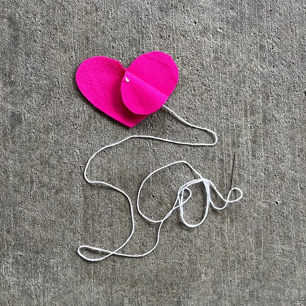 A cutout heart cutout attached to thread