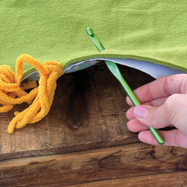 Pulling yarn to make a DIY horsey blanket