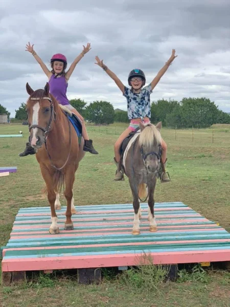 Finley and Evie on a horse and pony.