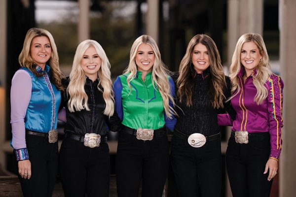 A group of equestrians wearing plain show shirts, which are a great option for competing at horse shows on a budget.