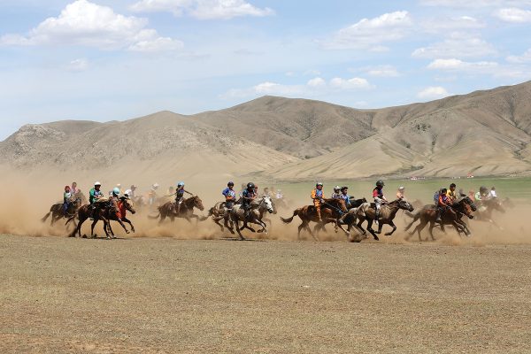 Young riders competing in horse racing in Mongolia