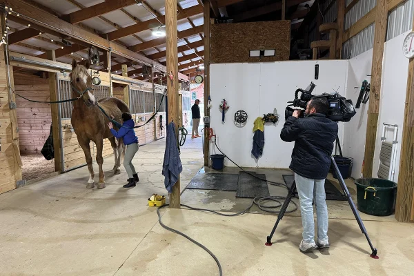 The news filming the inspiring young equestrian.