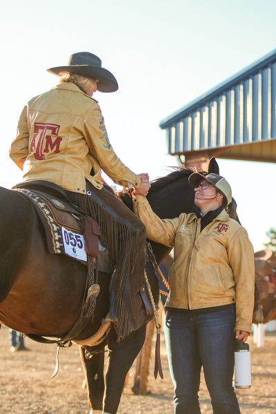 Paige Linne, coach of the Texas A&M University Ranch Horse Team, congratulates one of her members after her run.