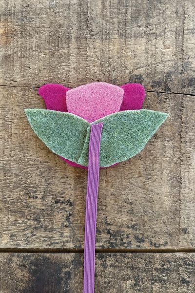 A flower created by felt cutouts.