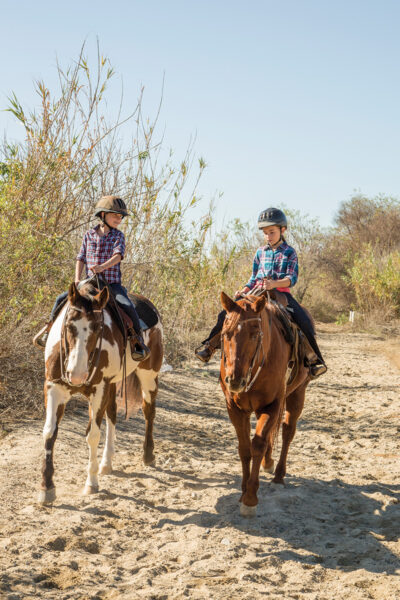 Two young riders trail riding