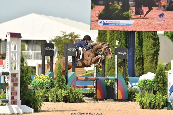 Nora competing in the jumper ring at Pony Finals.
