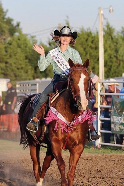 A waving rodeo queen