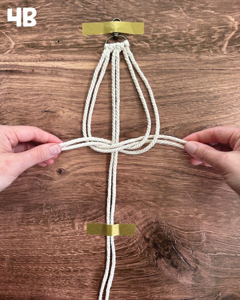 Pulling the ends of the thread tight.