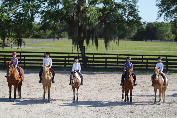 Young riders practice arena etiquette in a mock-show