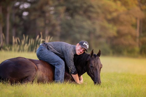 Michael Gascon laying down on a mare.