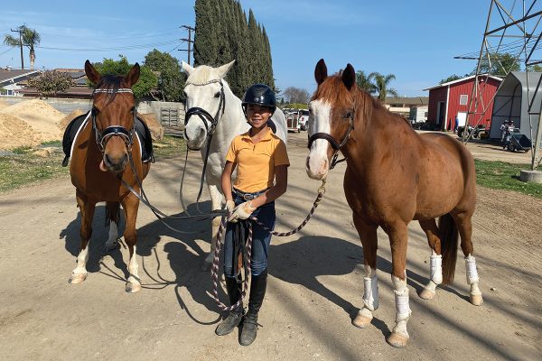 A young rider with her three horses. She manages horsekeeping them in Southern California.