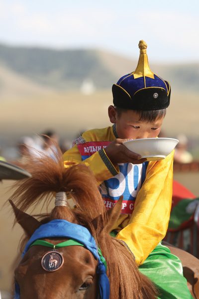 A child wins a medal and bowl of airag