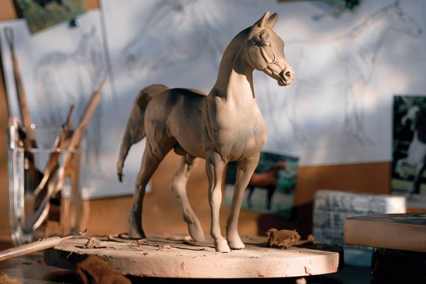 A clay sculpture of a horse.