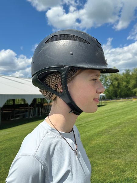 An example of a riding helmet with a proper fit while wearing a hairnet.