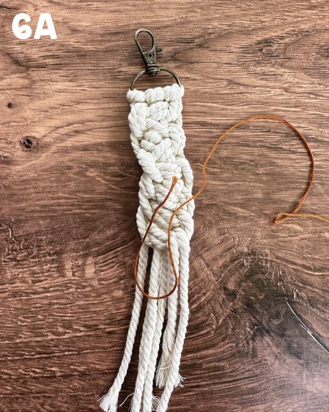 Creating a U with the embroidery thread when making a DIY horsey keychain.