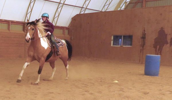 Rosie and Chief run home at the end of the barrel racing pattern.