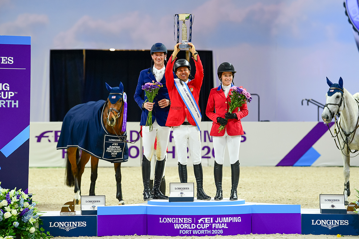 The USA's Kent Farrington hoists the Longines trophy on the FEI World Cup podium, alongside Germany's Daniel Deusser (second) and the USA’s Katie Dinan (third).