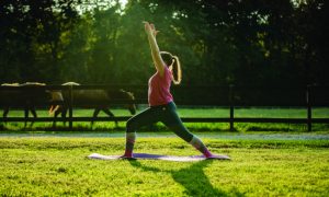 Person practicing yoga Warrior 1 pose.